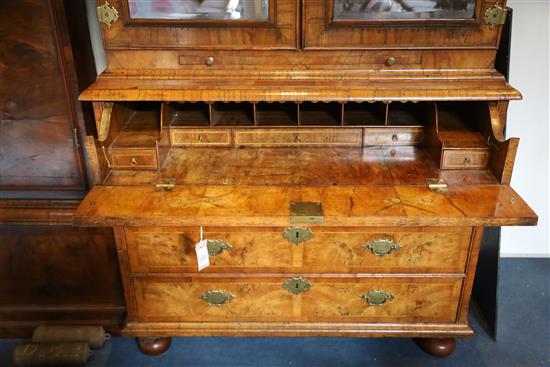 An early 18th century walnut double dome top secretaire cabinet, W.3ft 7in. D.1ft 10in. H.7ft 1in.